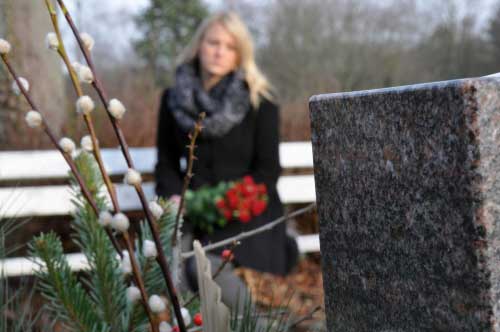 A woman at a grave site in Montgomery.