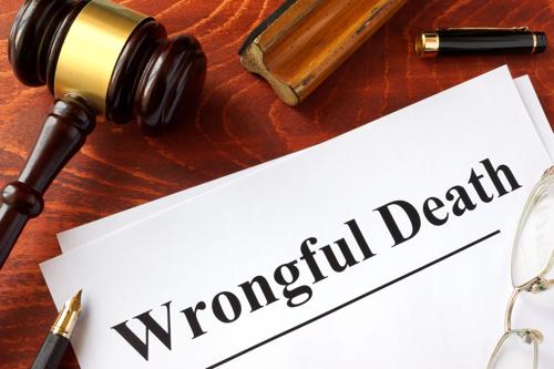 Paperwork for a wrongful death claim on a desk next to a gavel.