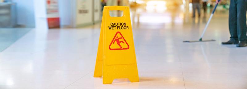 A wet floor sign in a store in Montgomery warning customers of a hazard.