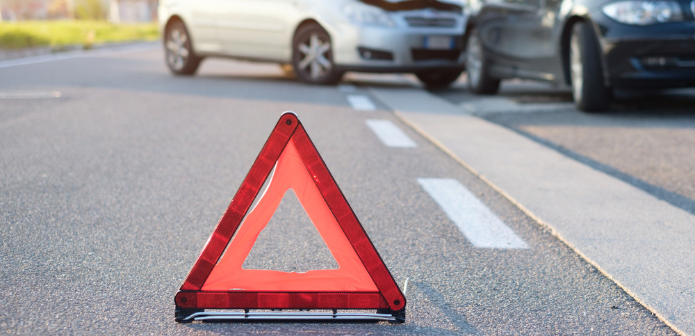 A caution sign in the middle of the road.